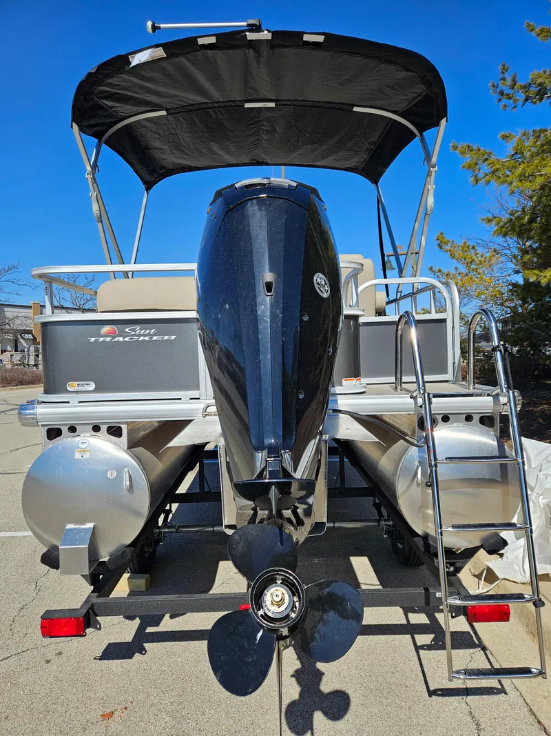 Slide: The Image of 2025 Sun Tracker Party Barge 18 DLX pontoon boat with outboard motor and canopy. - 5