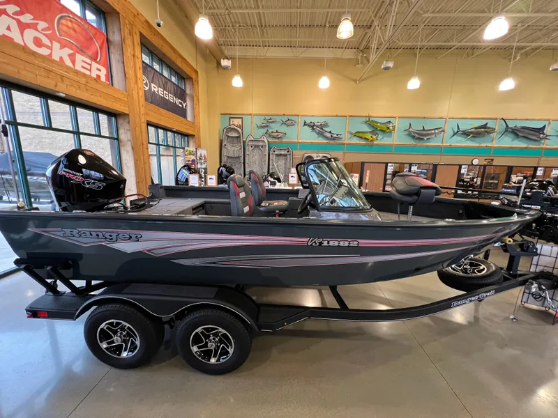 Slide: The Image of 2025 Ranger VS1882SC Reata boat displayed indoors on a trailer. - 2