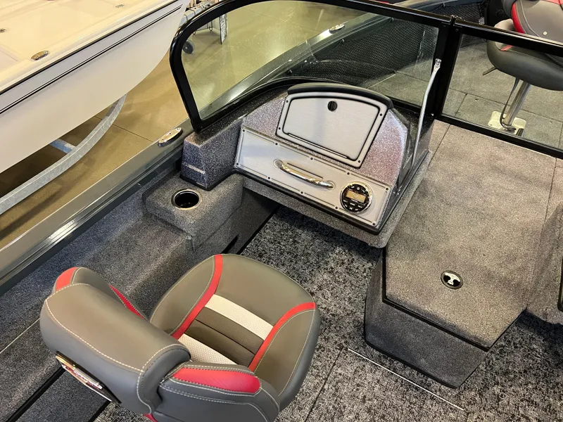 Slide: The Image of 2025 Ranger VS1882SC Reata boat interior with gray and red seating, dashboard, and carpeted flooring. - 5