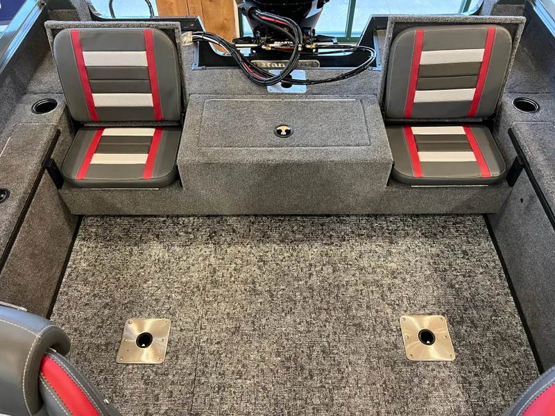 Slide: The Image of 2025 Ranger VS1882SC Reata boat interior with gray and red seating and carpeted flooring. - 7