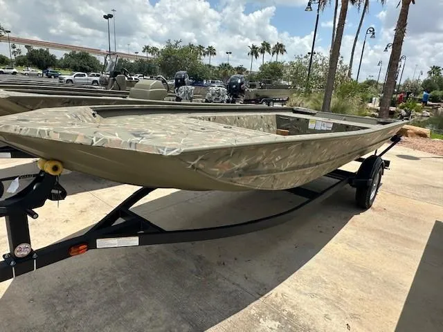 The Image of 2025 Tracker Grizzly 1754 Jon boat on trailer, parked outdoors under a cloudy sky. - 0