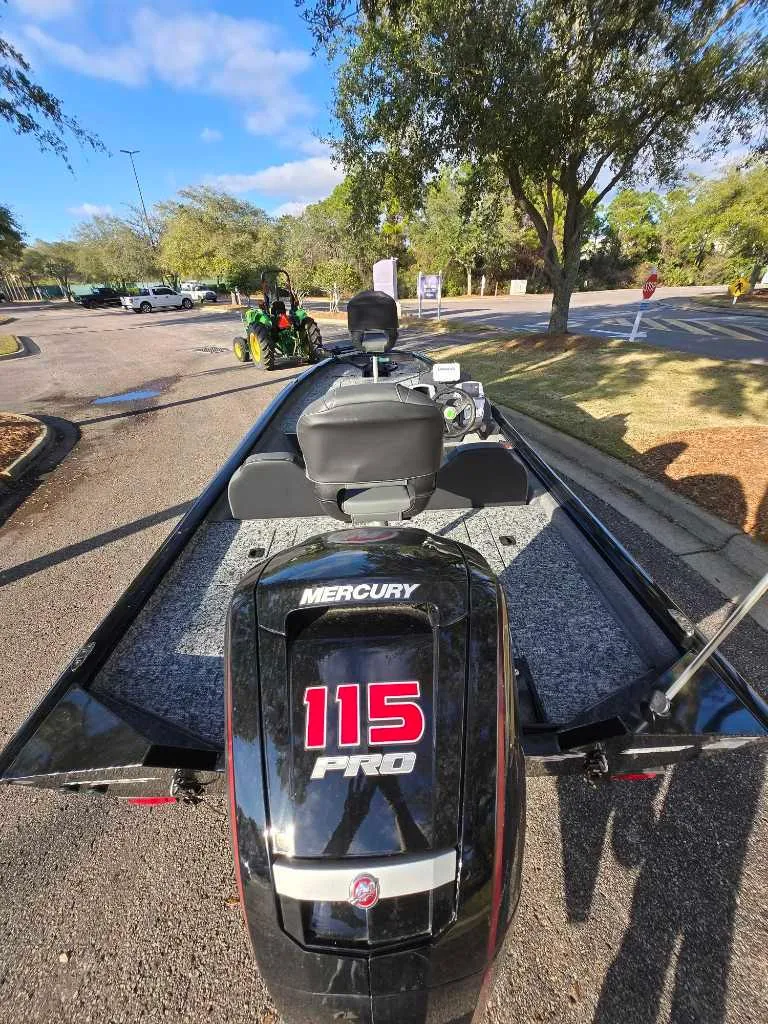 Slide: The Image of 2025 Tracker Pro Team 190 boat with Mercury 115 Pro engine, parked outdoors. - 3