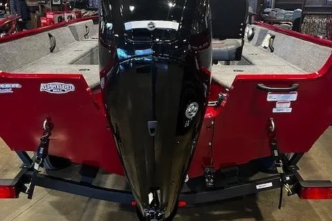 Slide: The Image of 2025 Tracker Pro Guide V-16 SC boat with red exterior and black motor. - 3