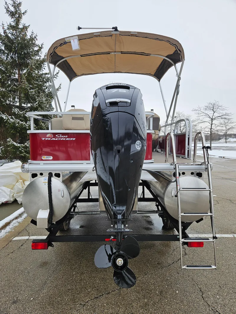 Slide: The Image of 2025 Sun Tracker Bass Buggy 18 DLX pontoon boat with outboard motor and canopy. - 5