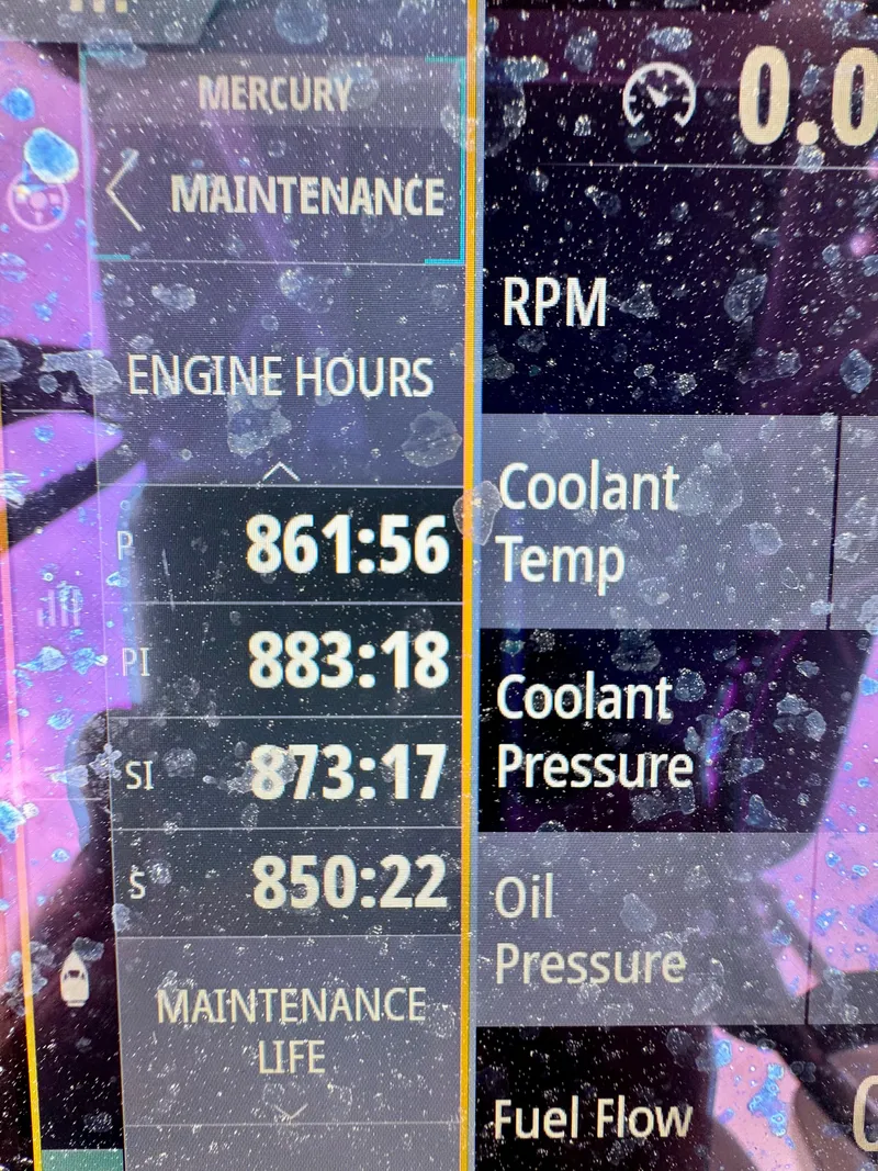 Slide: The Image of Display screen showing engine hours and maintenance data for 2022 Invincible 35 Catamaran. - 13