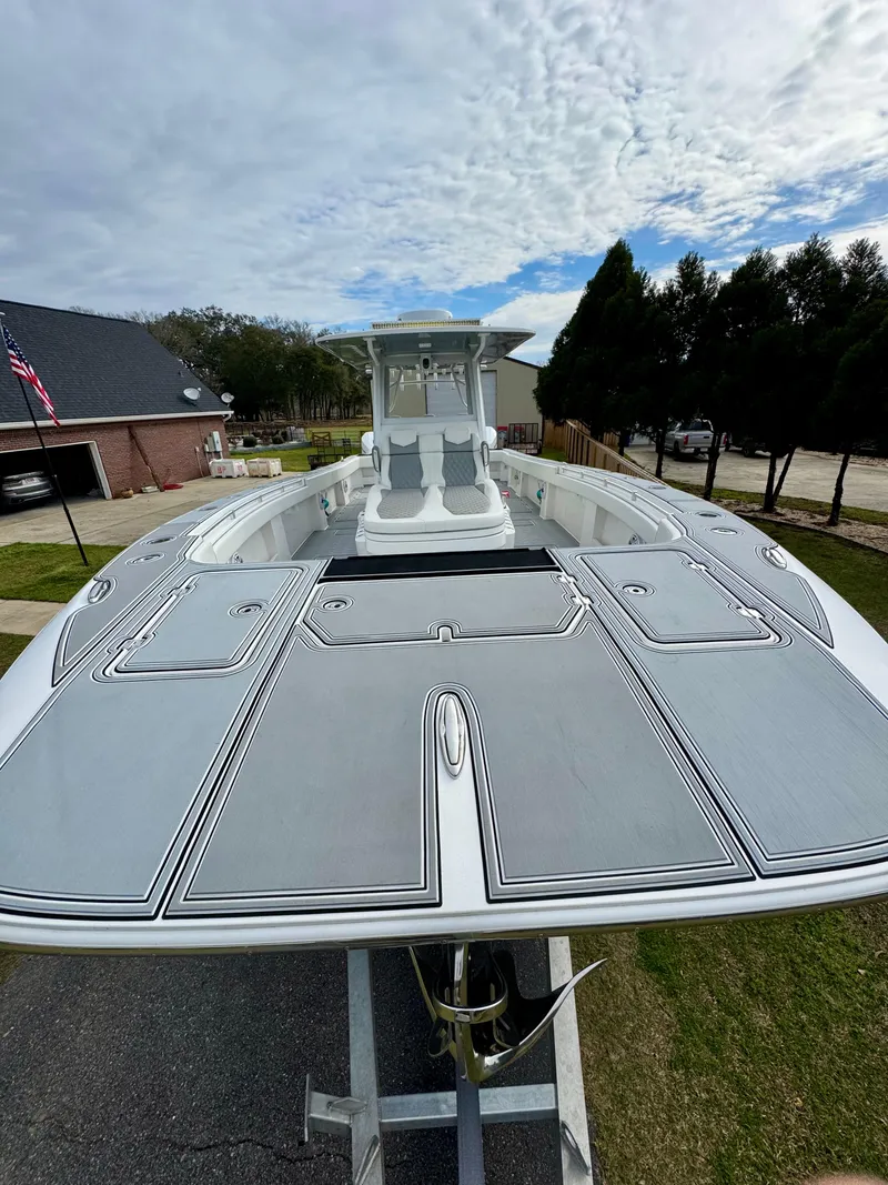 Slide: The Image of 2022 Invincible 35 Catamaran on trailer, showcasing sleek design and spacious deck. - 6