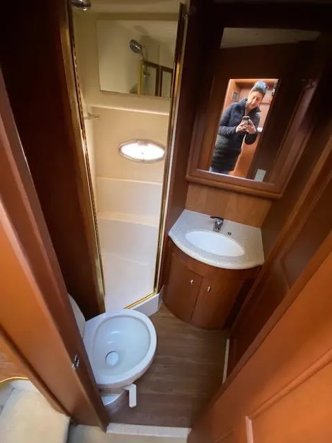 Slide: The Image of 2004 Silverton 39 Motor Yacht bathroom with shower, sink, and toilet. - 10