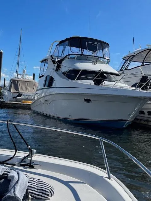 Slide: The Image of 2004 Silverton 39 Motor Yacht docked at marina under clear blue sky. - 3