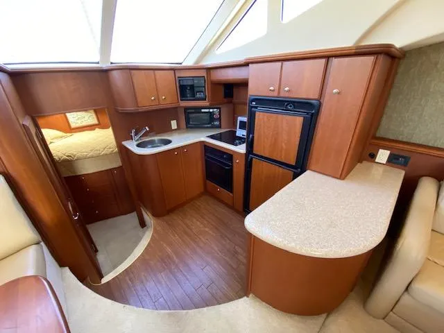 Slide: The Image of Interior of 2004 Silverton 39 Motor Yacht with modern kitchen and wood cabinetry. - 7