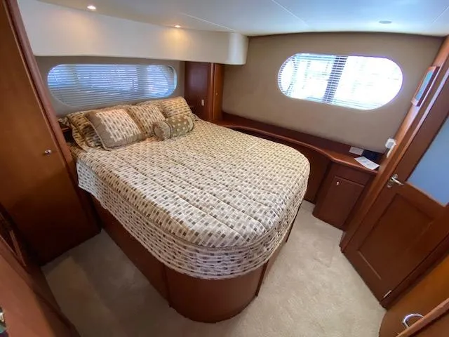 Slide: The Image of Luxurious bedroom interior of 2004 Silverton 39 Motor Yacht with elegant bedding and wood accents. - 8