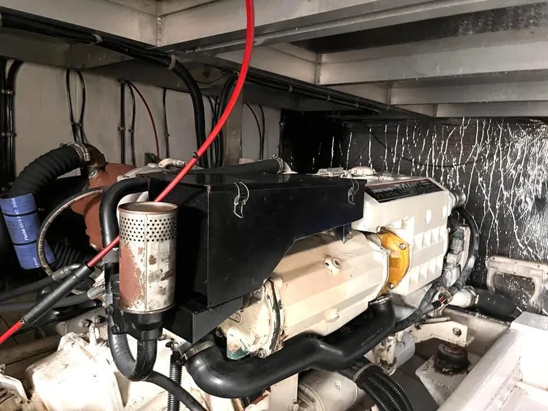 Slide: The Image of Engine room of a 1998 Navigator 53 yacht, showcasing mechanical components and wiring. - 37