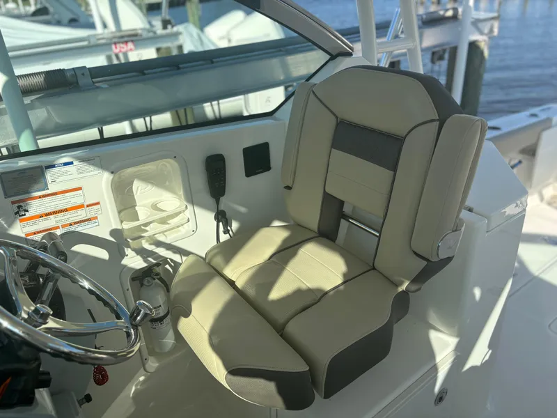 Slide: The Image of 2020 Pursuit DC 295 Dual Console boat seat and steering area. - 10