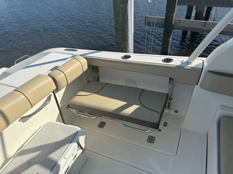 Slide: The Image of 2020 Pursuit DC 295 Dual Console boat interior with beige seating and cup holders. - 14