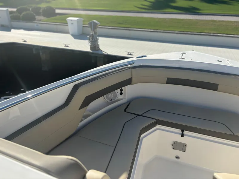 Slide: The Image of 2020 Pursuit DC 295 Dual Console boat interior with cushioned seating and sleek design. - 6