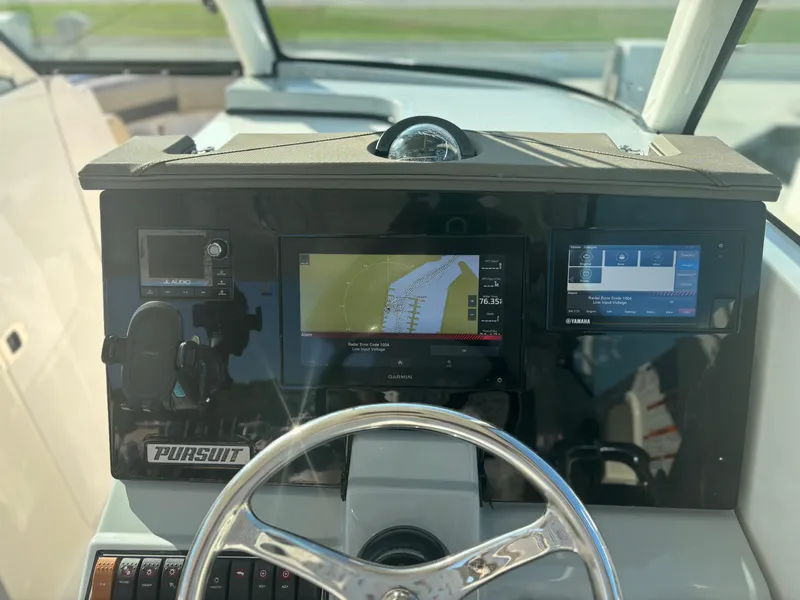 Slide: The Image of 2020 Pursuit DC 295 Dual Console dashboard with navigation and control systems. - 9