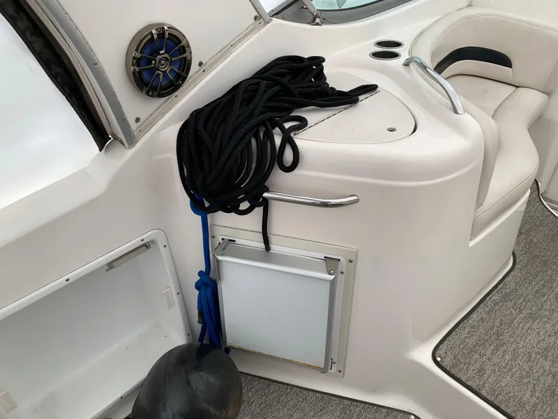 Slide: The Image of 2000 Chaparral Signature 300 boat interior with speaker, rope, and seating area. - 2