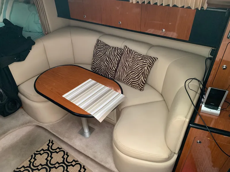 Slide: The Image of Interior of 2000 Chaparral Signature 300 with beige seating and wooden table. - 5