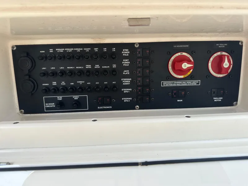 Slide: The Image of Control panel of a 2020 Pathfinder 2500 Hybrid boat, featuring switches and dials. - 15