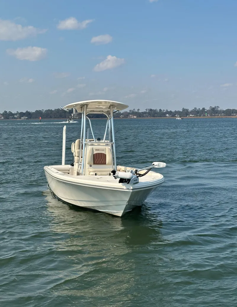 Slide: The Image of 2020 Pathfinder 2500 Hybrid boat on calm water under a clear sky. - 19