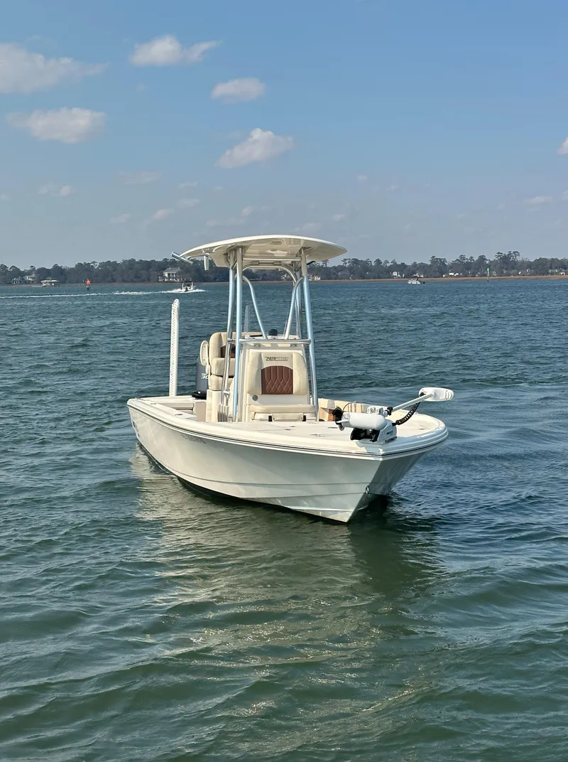Slide: The Image of 2020 Pathfinder 2500 Hybrid boat on calm water under a clear sky. - 20