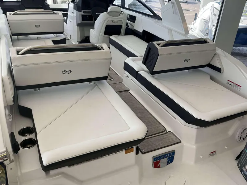 Slide: The Image of 2025 Cobalt R6 boat interior with luxurious white seating and modern design. - 11