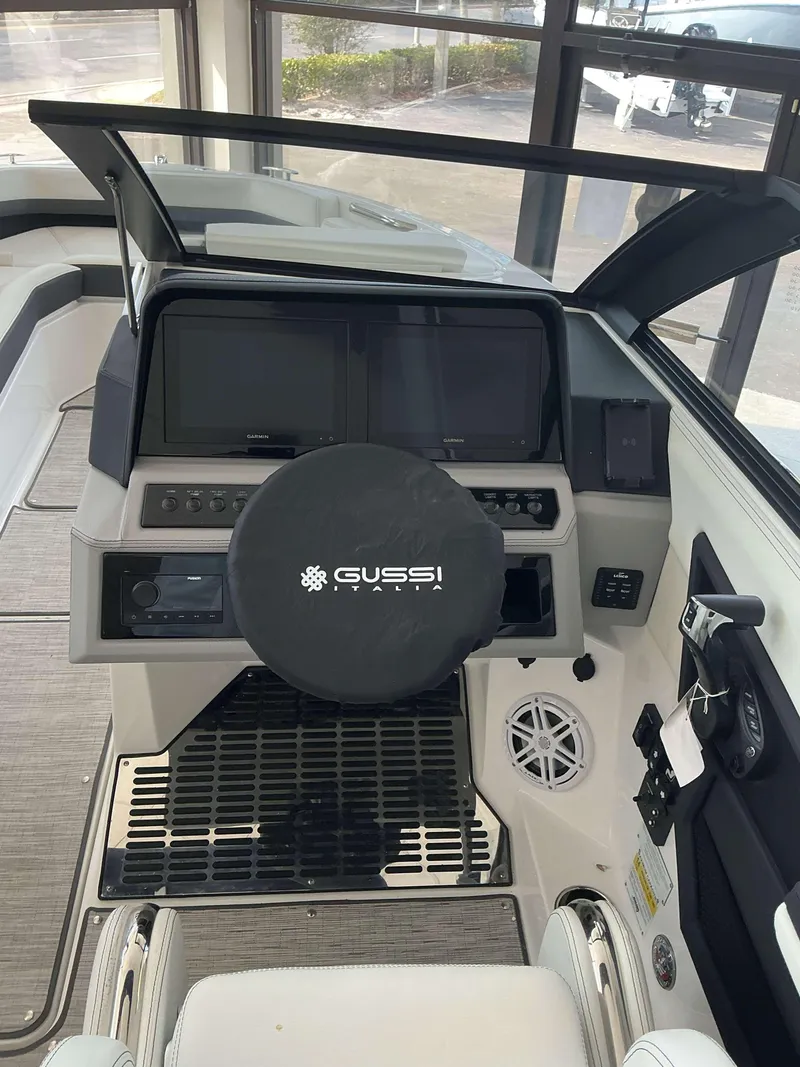 Slide: The Image of 2025 Cobalt R6 boat helm with Gussi Italia steering wheel and dual displays. - 6