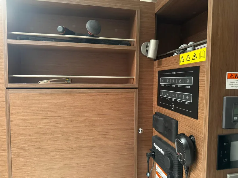 Slide: The Image of Coiled white cable in wooden compartment on Beneteau Oceanis 34.1, 2024 model. - 17