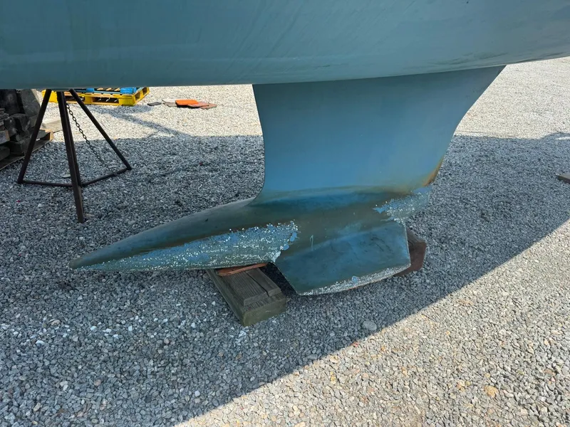 Slide: The Image of 2024 Beneteau Oceanis 34.1 keel on gravel, showing wear and marine growth. - 27