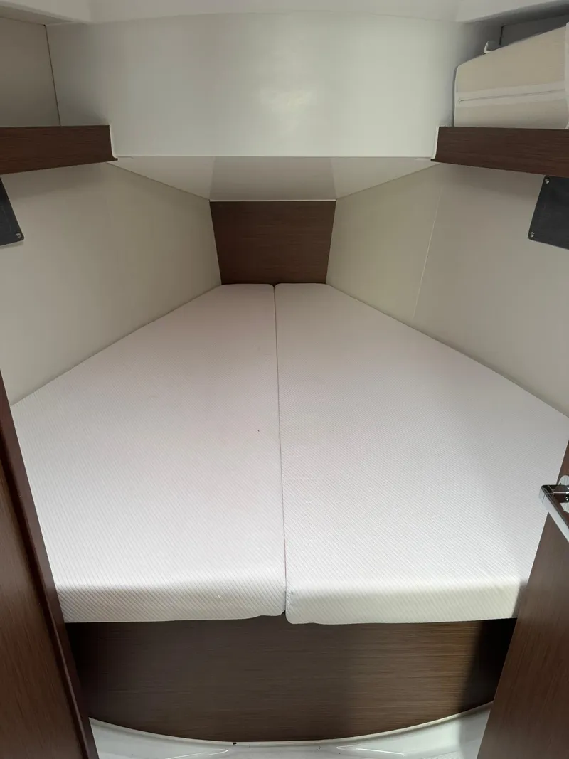 Slide: The Image of Interior cabin of 2024 Beneteau Oceanis 34.1 sailboat, featuring sleek wood and fabric design. - 7