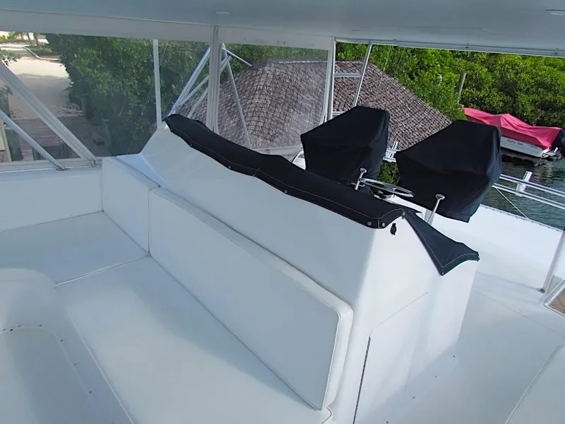 Slide: The Image of 1999 Viking Boats Convertible interior with white seating and covered controls. - 14