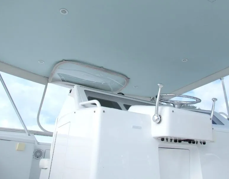 Slide: The Image of 1999 Viking Boats Convertible helm station with steering wheel and controls. - 15