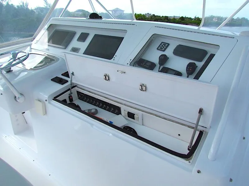 Slide: The Image of 1999 Viking Boats Convertible helm with open control panel, featuring navigation instruments and controls. - 17