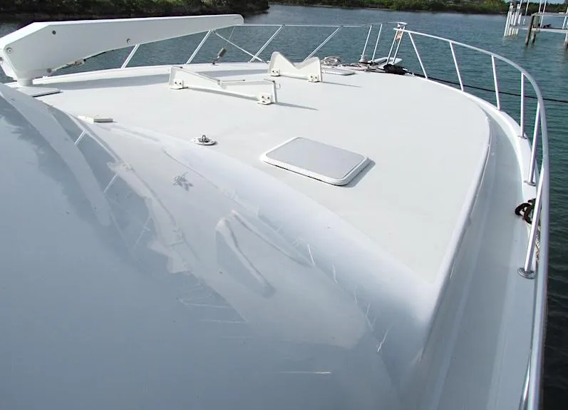 Slide: The Image of 1999 Viking Boats Convertible yacht deck with sleek white finish and railing. - 2