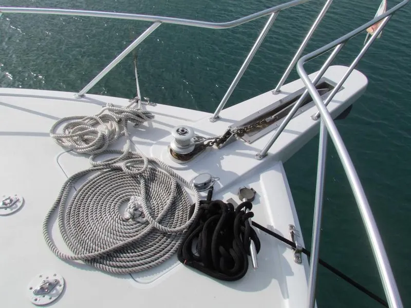 Slide: The Image of Bow of 1999 Viking Boats Convertible with ropes and anchor chain on deck. - 25