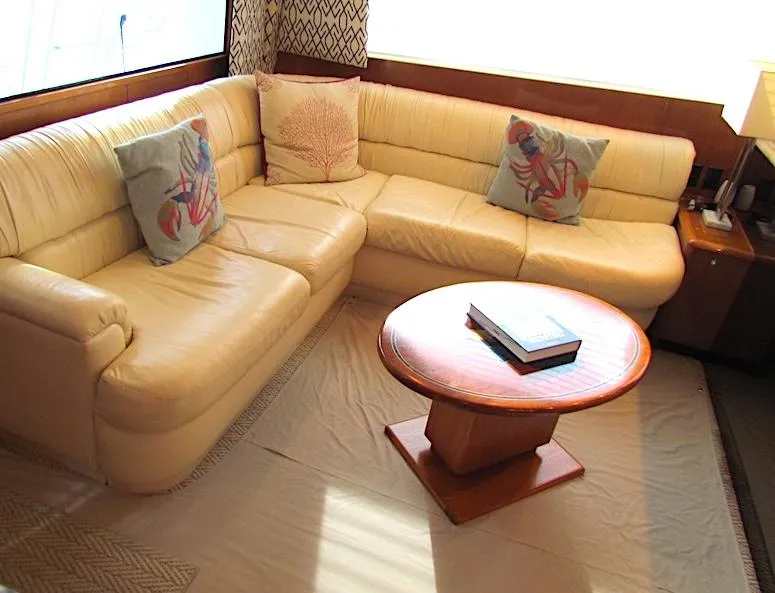 Slide: The Image of 1999 Viking Boats Convertible interior with beige leather sofa and round wooden table. - 33
