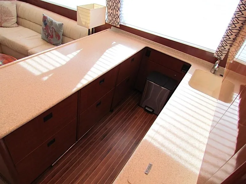 Slide: The Image of Interior of 1999 Viking Boats Convertible with sleek countertops and wooden flooring. - 36