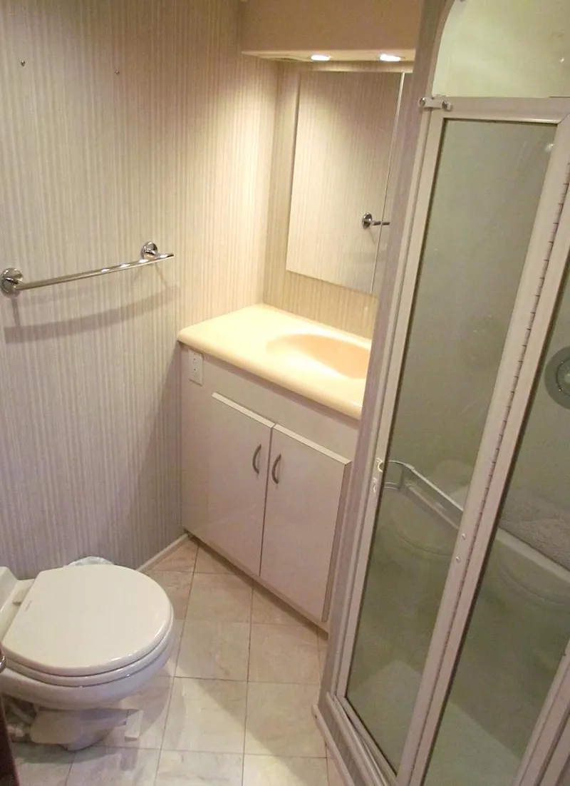 Slide: The Image of 1999 Viking Boats Convertible bathroom with shower, sink, and toilet. - 38