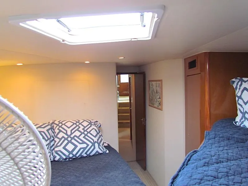 Slide: The Image of Interior cabin of 1999 Viking Boats Convertible with cozy bedding and natural light. - 41