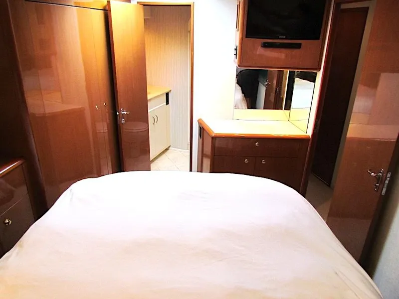 Slide: The Image of Interior cabin of 1999 Viking Boats Convertible with bed, cabinets, and TV. - 44