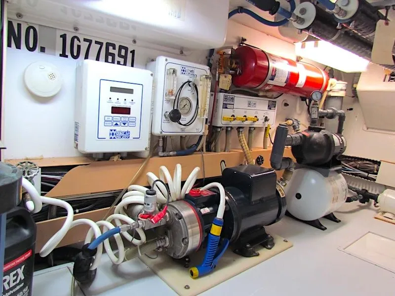 Slide: The Image of Engine room of 1999 Viking Boats Convertible with equipment and wiring. - 49