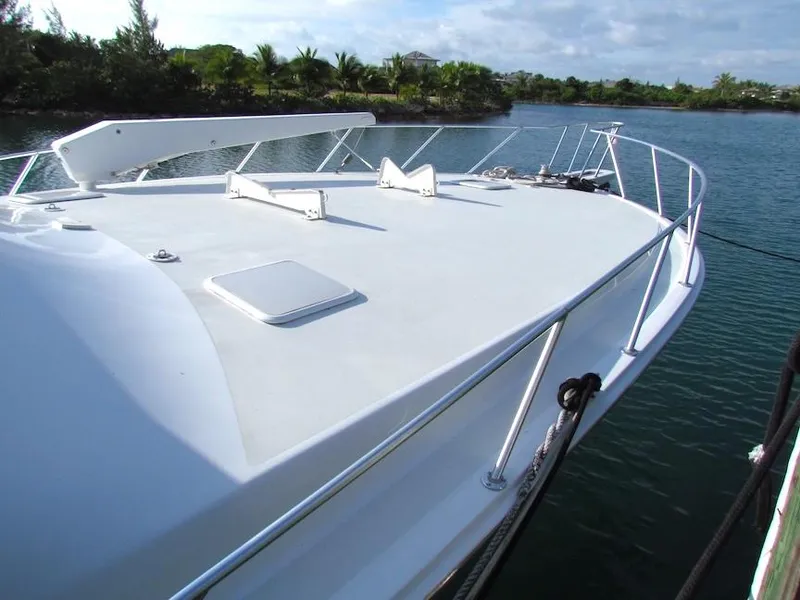 Slide: The Image of 1999 Viking Boats Convertible yacht docked on a serene waterway. - 5