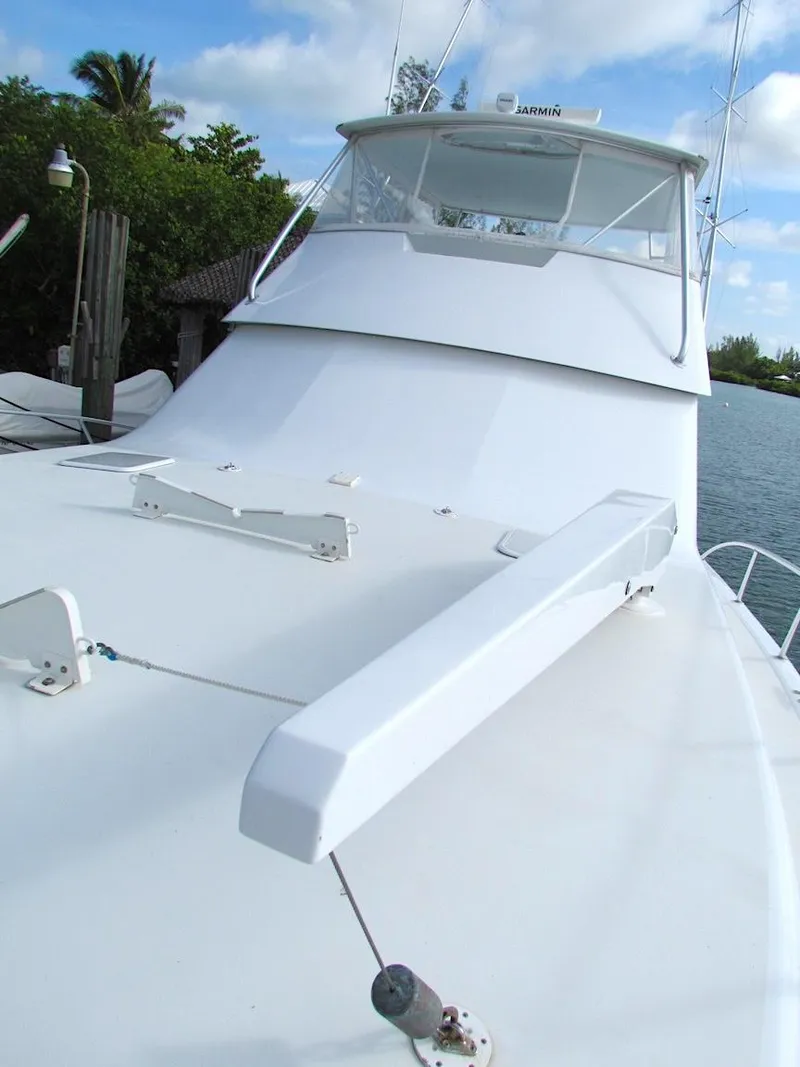 Slide: The Image of 1999 Viking Boats Convertible on water, showcasing sleek design and spacious deck. - 6