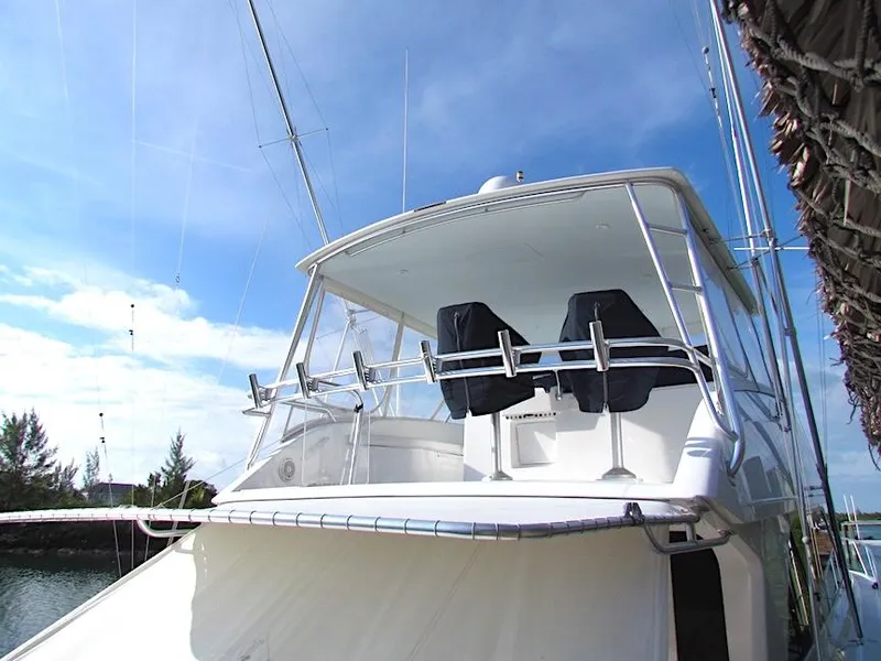 Slide: The Image of 1999 Viking Boats Convertible yacht docked under clear blue sky. - 7
