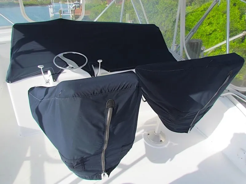 Slide: The Image of 1999 Viking Boats Convertible helm covered with protective fabric on a sunny day. - 8