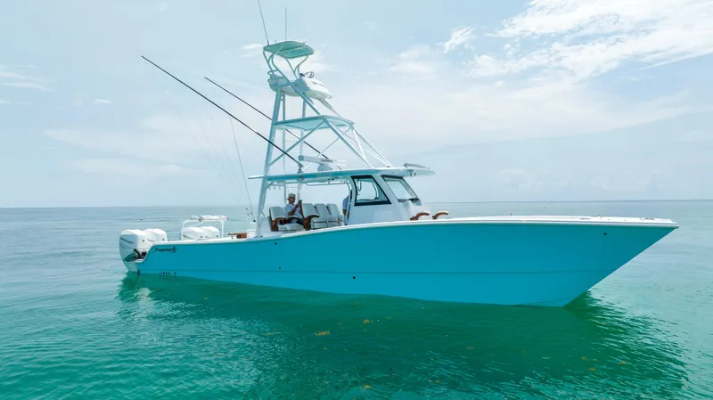 Slide: The Image of 2026 Freeman 43 boat on clear blue water, featuring sleek design and powerful engines. - 2