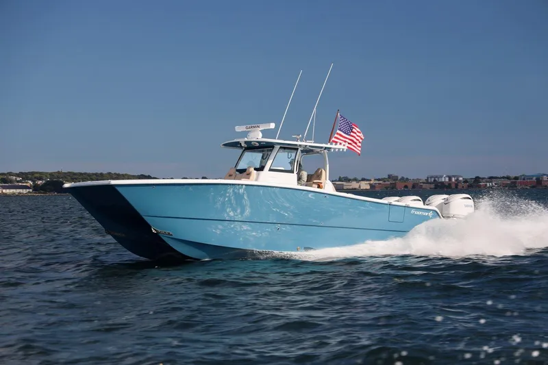 The Image of 2026 Freeman 38 boat cruising on water with American flag. - 0