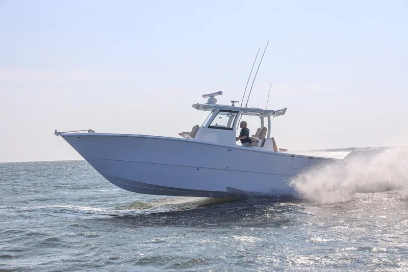 Slide: The Image of 2026 Freeman 35 boat cruising on open water, creating a splash. - 1