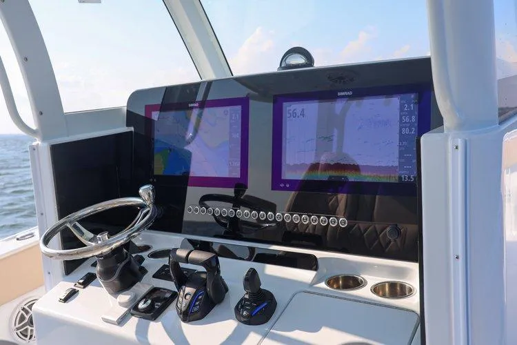 Slide: The Image of Helm of 2026 Freeman 35 boat with dual navigation screens and controls. - 4