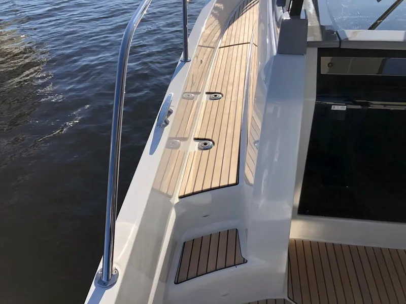 Slide: The Image of 2024 Jeanneau Leader 12.5 WA boat deck with sleek design and wood finish. - 16