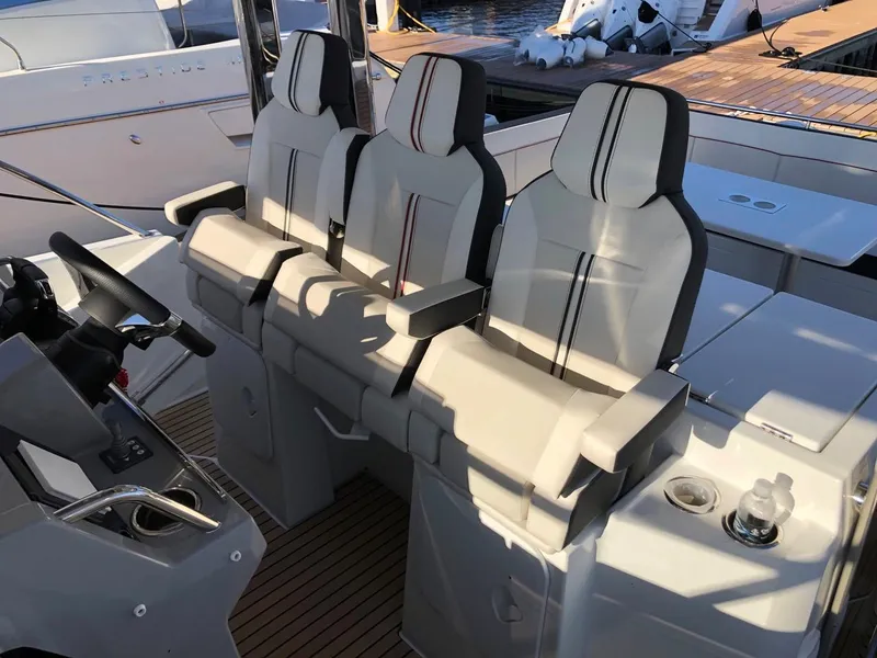 Slide: The Image of 2024 Jeanneau Leader 12.5 WA boat interior with three cushioned seats. - 17